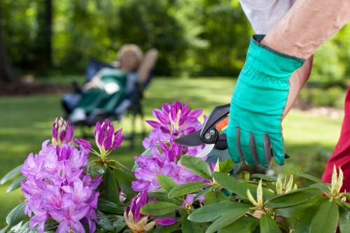 Gardeners wearing PPE and carrying tools on a maintained Yeading property