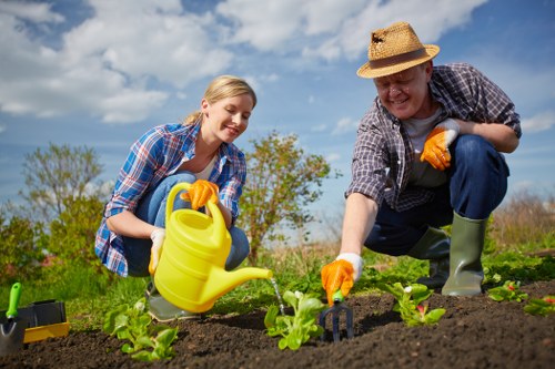 Gardener finishing tidy, demonstrating safe, compliant practices