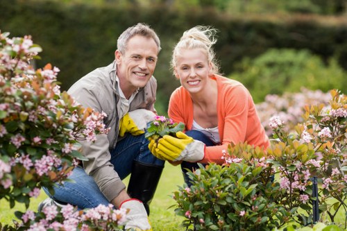 Worker trimming a hedge symbolizing service performance and reliability
